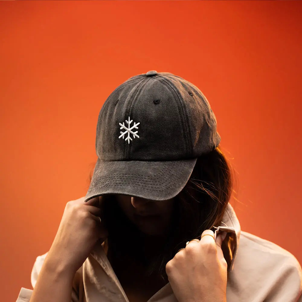 Girl wearing a black Panic Zones Snowflake Cap  — official Panic Zones Arctic Edition merch