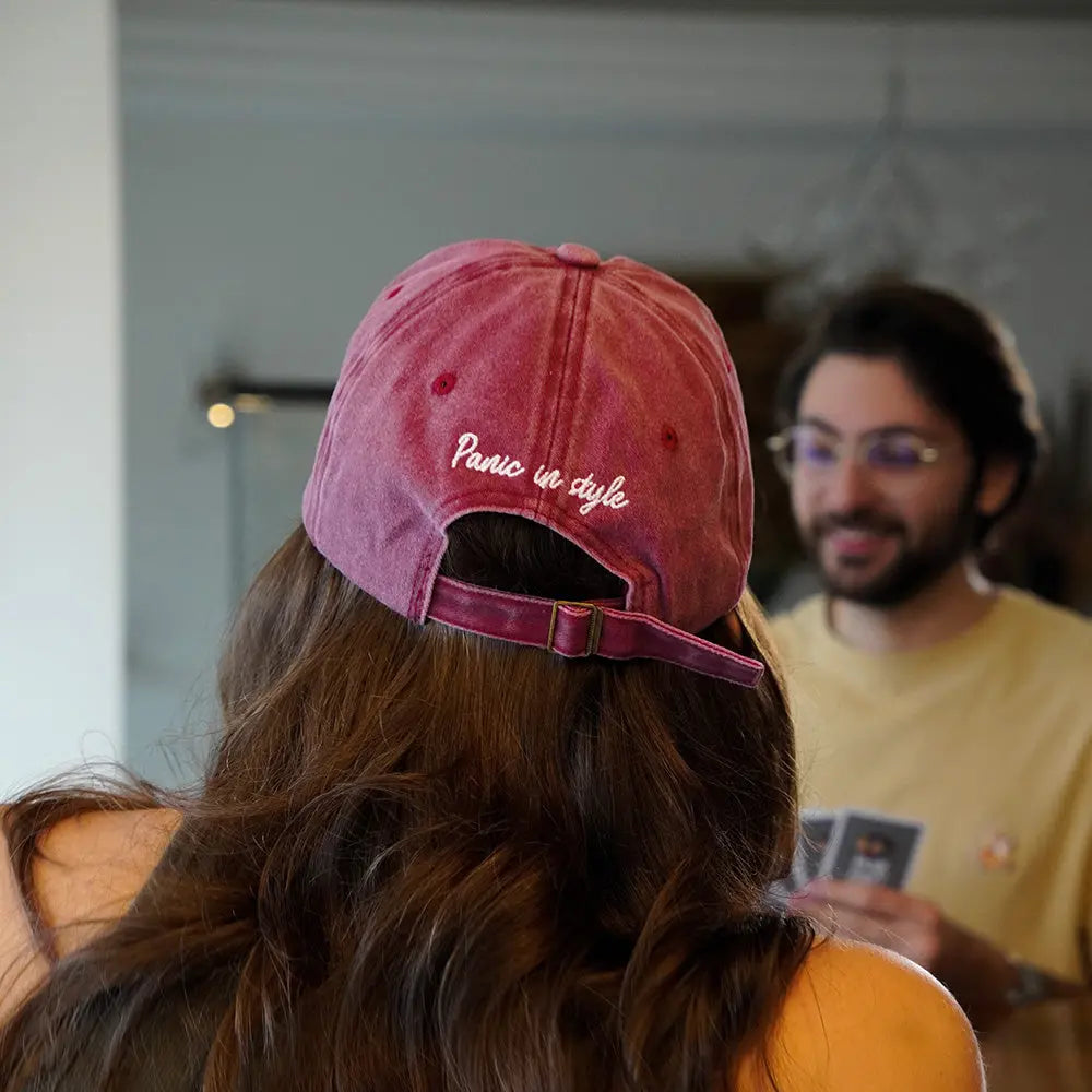 Girl wearing a red Panic Zones Snowflake Cap with "Panic in Style" text — official Panic Zones Arctic Edition merch