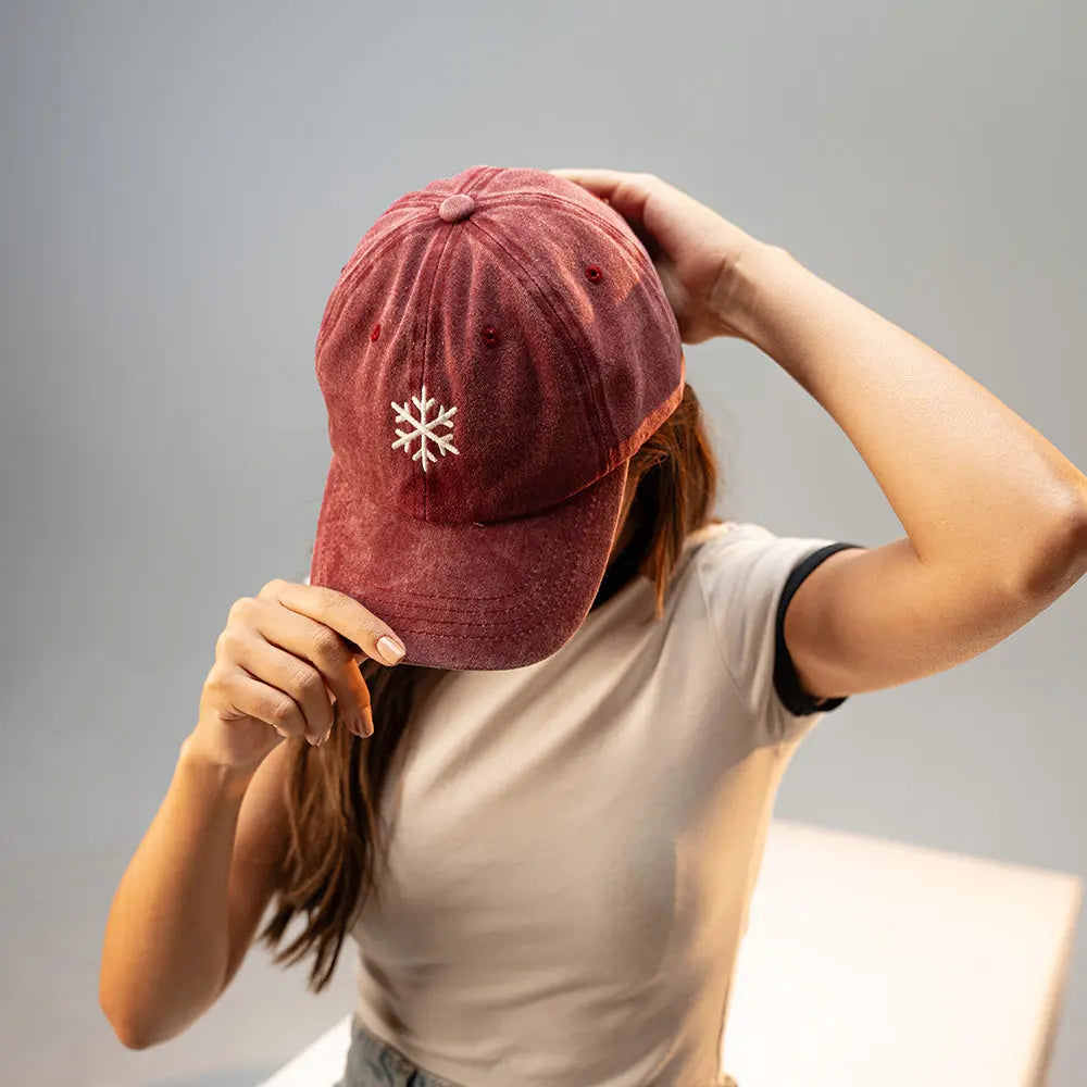 Girl wearing a red Panic Zones Snowflake Cap — official Panic Zones Arctic Edition merch